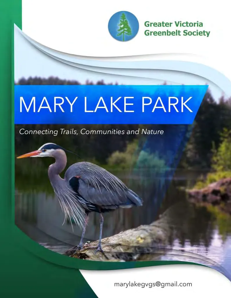 A great blue heron standing on a log in a lake