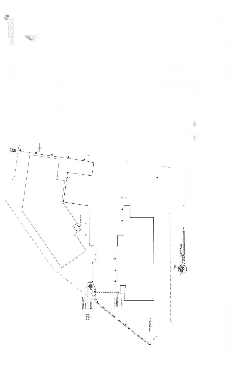 Site plan showing building footprints, electrical service points, and proposed luminaire locations. A red dashed rectangle highlights a specific area of the electrical layout near the center of the site.