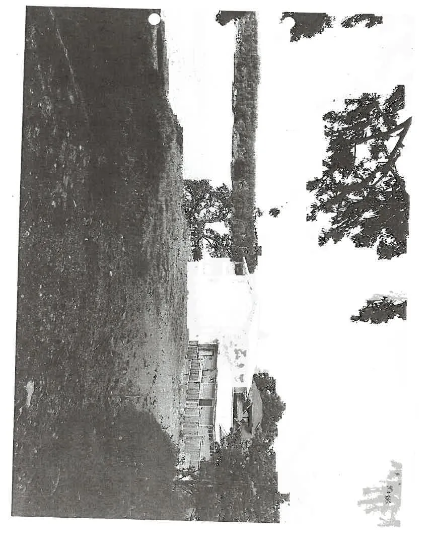 Photo of the rocky outcrop and metal gate on the property