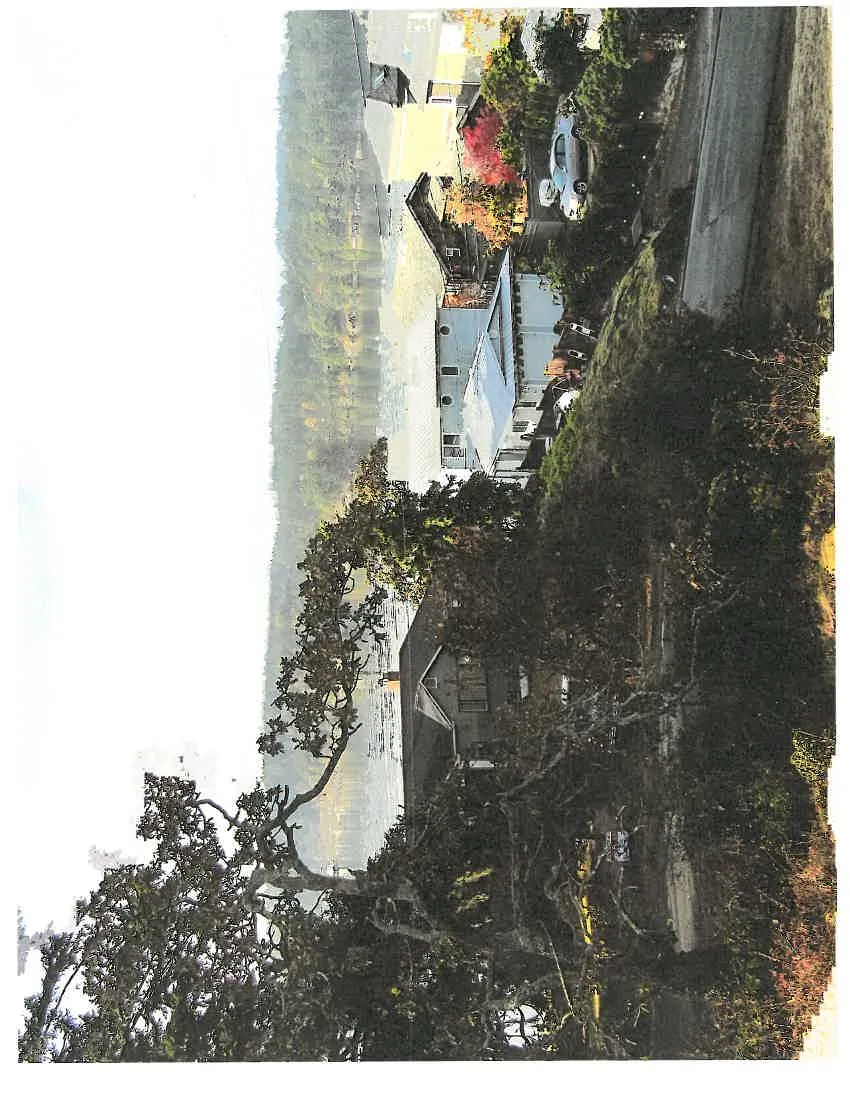 Photograph of the ocean view and neighboring residential rooftops from 307 Beaumont Avenue